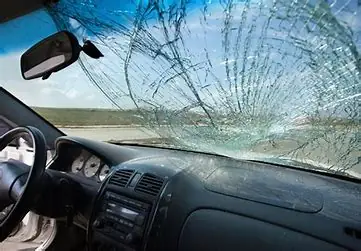 A cracked windshield seen from inside the car
